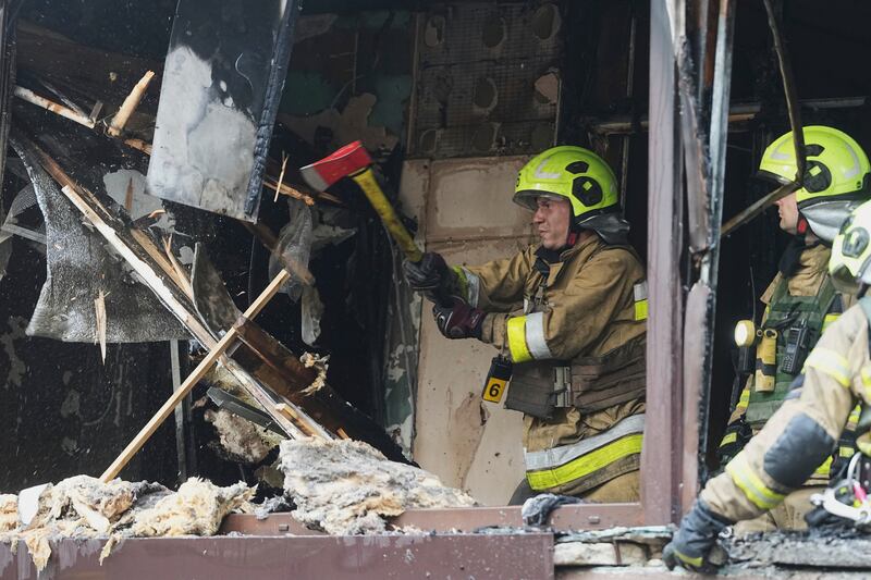 Firefighters work in a destroyed apartment building after a Russian attack in Kyiv, Ukraine, Monday, July 21, 2025. (AP Photo/Efrem Lukatsky)