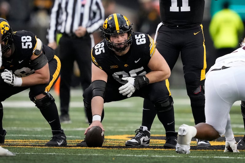 FILE - Iowa center Logan Jones gets set for a play during the second half of an NCAA college football game against Minnesota, Saturday, Oct. 25, 2025, in Iowa City, Iowa. (AP Photo/Charlie Neibergall, File)