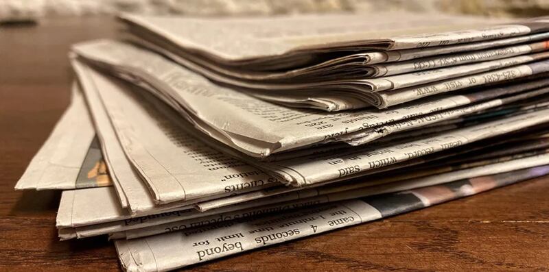 A stack of newspapers is pictured at the Illinois State Capitol.