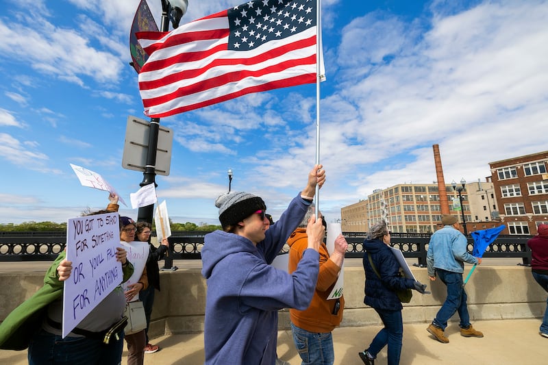 Organized by Indivisible SRFD, a group marches across the First Avenue bridge into Sterling Saturday, May 3, 2025, to protest the Trump administration and show their support for workers’ rights. The crowd started at RB&W Park in Rock Falls and marched to Grandon Civic Center in Sterling.