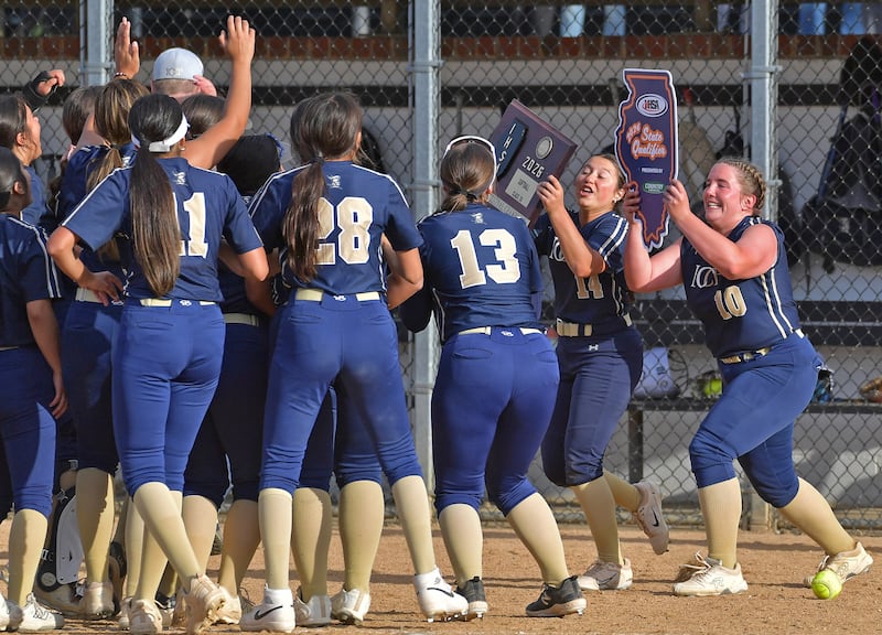 IC Catholic’s Sofia Bucaro (14)and Madelynn Dinino (10) present the IHSA championship plaques to teammates following their win over Stillman Valley in the Class 2A Benedictine Supersectional game on June 1, 2026 at Benedictine University in Lisle.