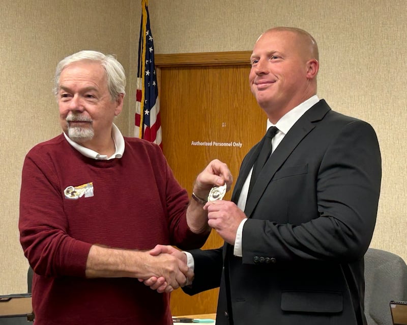 Oregon Mayor Ken Williams (left) poses with the city's newest detective, Kevin Most, following a swearing in ceremony at City Hall on Tuesday, Oct. 28, 2025.