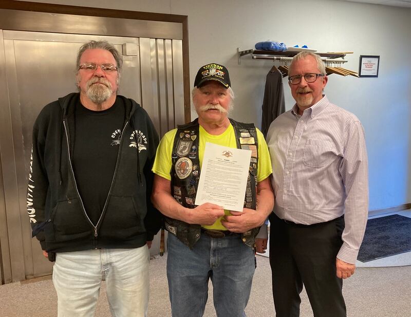 Open Roads A.B.A.T.E. Activities Coordinator Kevin Smith, Open Roads A.B.A,T.E. President Cliff Oleson with the proclamation signed by Plano Mayor Mike Rennels recognizing May as Motorcycle Awareness Month at a city council meeting.