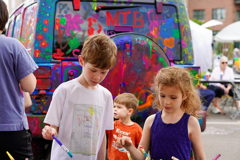 Paintbrush in hand, children test out their artistic talents at the 27th St. Charles Fine Art Show's 'Paint-A-Car' activity zone hosted by the Pottawatomie Garden Club. The show featured more than 110 artists, displaying everything from ceramics, photography, paintings, and sculptures.