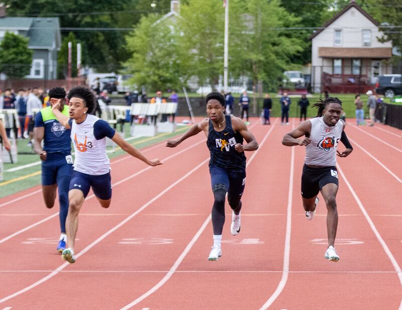 Oswego High School’s Dontrell Young, right, wins the 100-meter race which qualifies him for the state finals during the Boys Track and Field Class 3A East Aurora Sectional hosted by East Aurora High School in Aurora on Thursday, May 22, 2025.