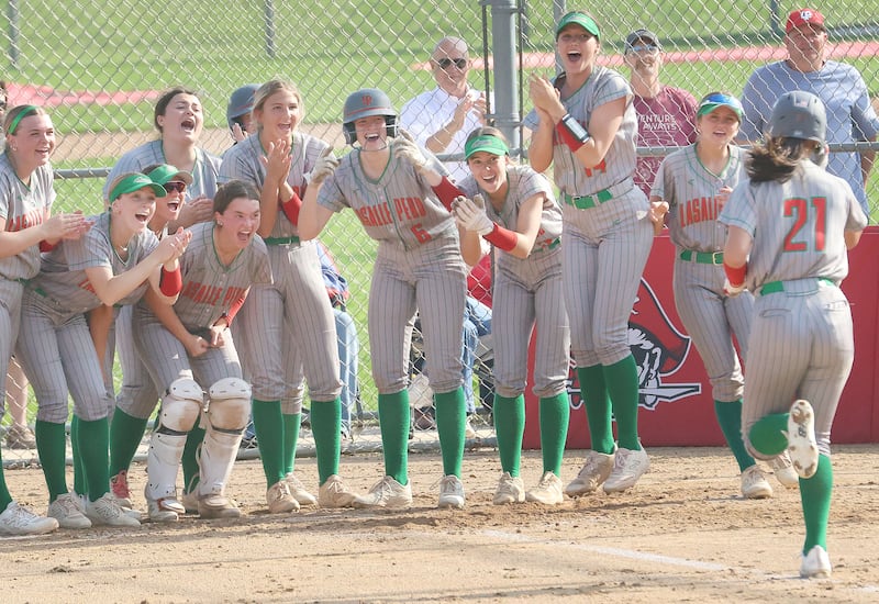 L-P's Anna Riva (right) is greeted by her teammates at home plate after hitting a home run against Ottawa on Tuesday, April 14, 2026 at Ottawa High School.