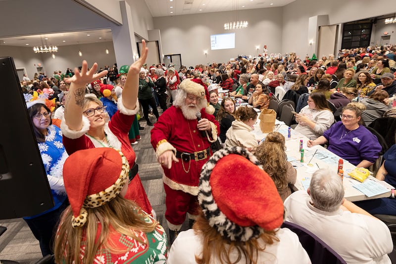 Santa points to contestants in the Hometown Holidays Bingo Christmas costume contest Thursday, Nov. 20, 2025, in Rock Falls.