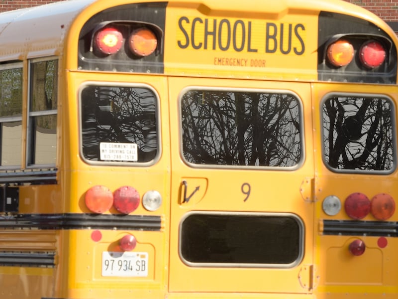 Students exit a school bus as they enter Hinckley-Big Rock Middle School that is part of School District 429 on Tuesday, April 27, 2021.