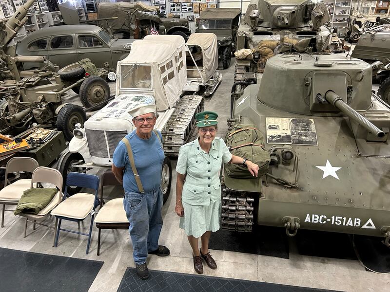 Charles and Lydia Roberts stand among their many WWII vehicles at Roberts Armory, a WWII historical museum near Rochelle. The museum also features other memorabilia and items from the era.