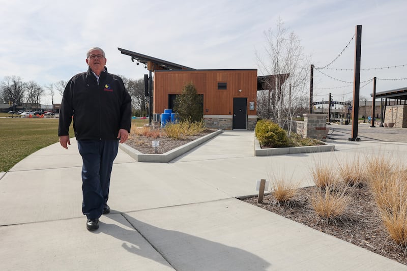 Bourbonnais Mayor Paul Schore walks along the sidewalk at the new Bourbonnais community campus, The Grove, which open in June of 2024, during his last week in office on Wednesday, April 16, 2025.