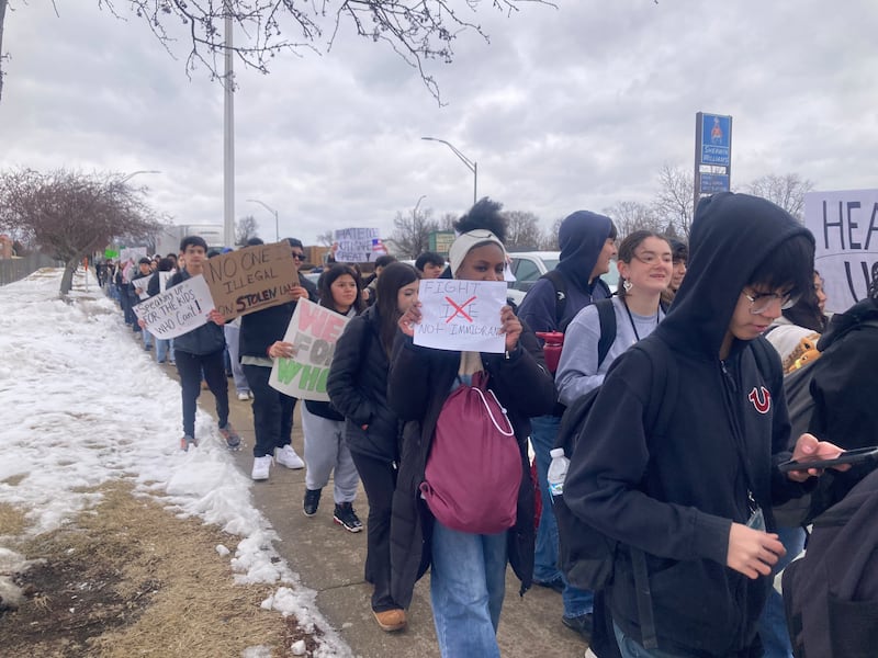 Students from Joliet West High School hold signs as they march down Larkin Avenue after walking out of school to protest the actions of Immigration and Customs Enforcement agents on Friday, Feb. 6, 2026.