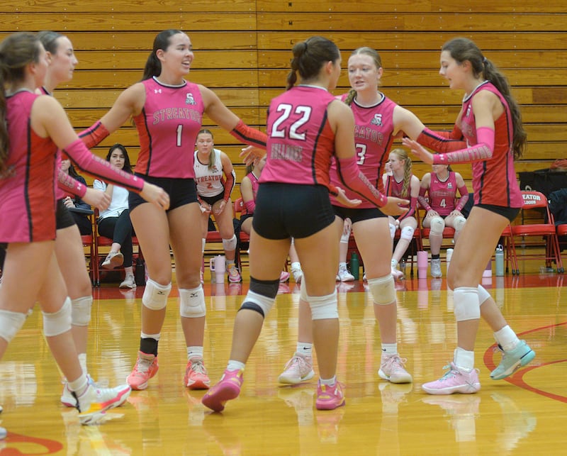 The Lady Bulldogs celebrate taking the lead against Wilmington during the 2nd set of Tuesday’s match at Streator.