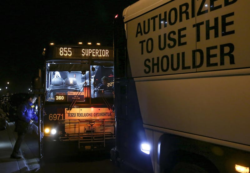 A morning commuter boards the 6971 Pace Express bus outside Plainfield Village Hall in Plainfield in this undated file photo.