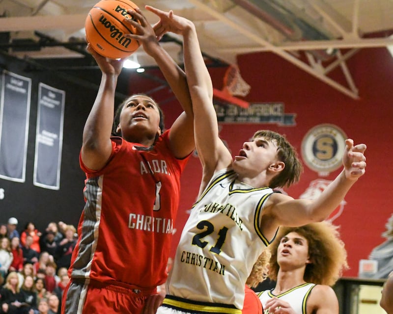 Yorkville Christian's Joradan Purvis (21) tries to block the shot of Aurora Christian's Jordan Weeks (5) during the regional title game on Friday Feb. 28, 2025, held at Indian Creek High School.