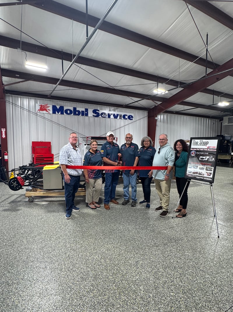 Morris Building and Zoning Officer Bill Martin, Acumen Motorsport owners Doug and Patricia Grunnet, Operations Manager Herb Wyeth, Deb Wyeth, Morris Community Affairs Officer Stan Knudson, and Grundy Chamber President & CEO Christina Van Yperen celebrate the new downtown business with a Chamber ribbon cutting Oct. 9.