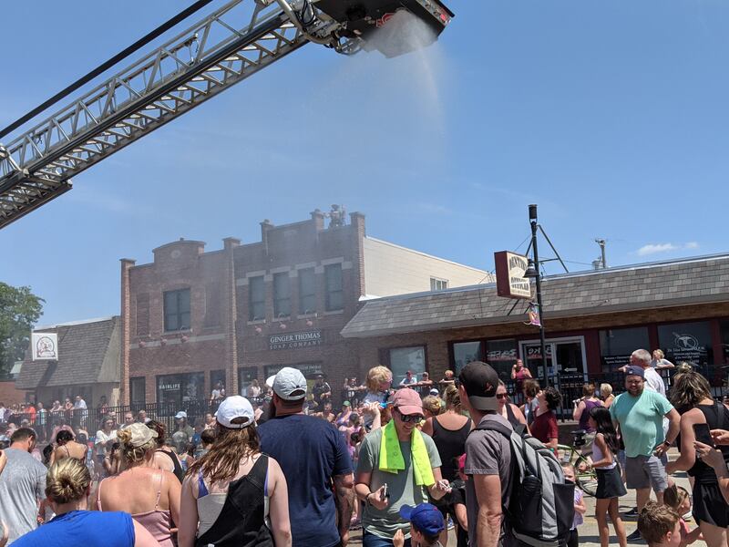 To cool off those who had been watching the PrairieFest Parade on June 16, Oswego firefighters used one of their fire trucks to spray water on the crowd.