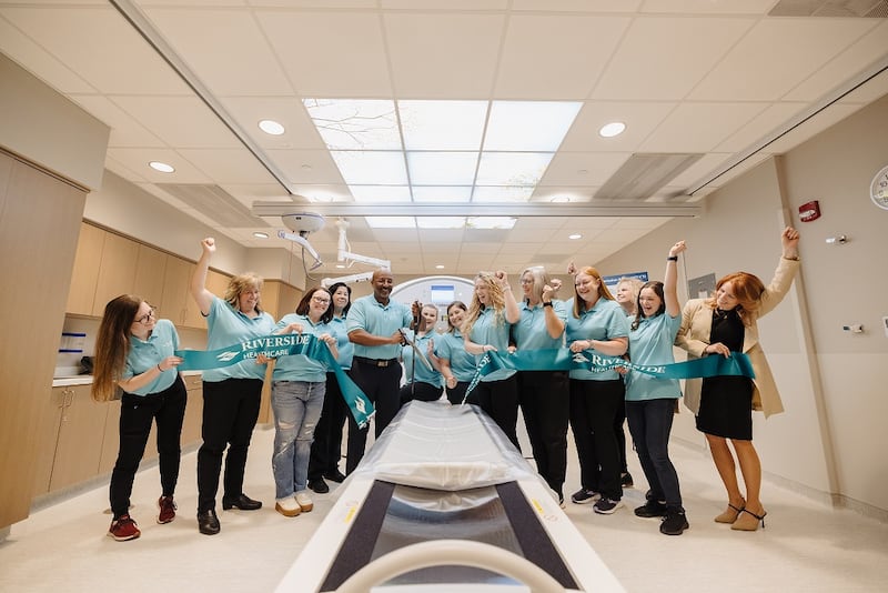 The imaging services team at Riverside Healthcare celebrates cutting the ribbon on the new PET/CT scanner on May 21 during an open house event.