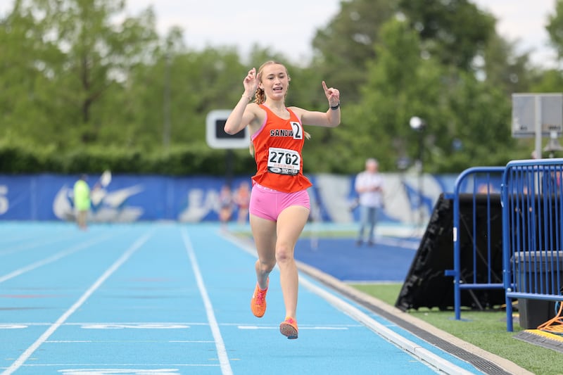 Sandwich’s Sunny Weber celebrates as she sets the new record in the 1600 m run during the IHSA Class 2A Girls Track & Field State Finals on Saturday, May 24, 2025.