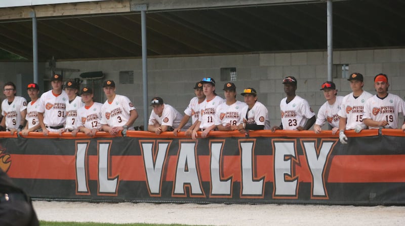 Illinois Valley Pistol Shrimp players watch from the dugout while playing the Normal Corn Belters during the teams home opener on Friday, May 30, 2025 at Schweickert Stadium in Peru.