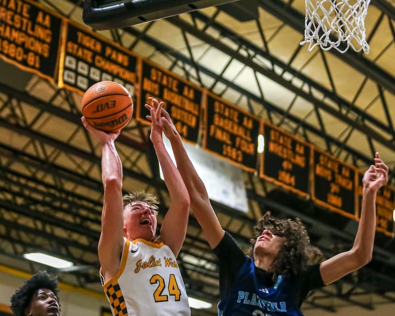 Joliet West's Ryan Lipke (24) draws a foul from Plainfield South's Isaiah Robertson (33) during their basketball game between Plainfield South at Joliet West, Feb 2, 2026 in Joliet.