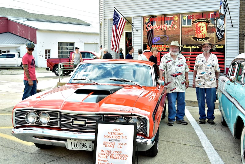 Brothers Lloyd (left) and Louis DeShane, displaying their custom Route 66 shirts, brought their classic cars down to Washington Street on Friday, Aug. 22, 2025, for the Prophetstown Proud car show.