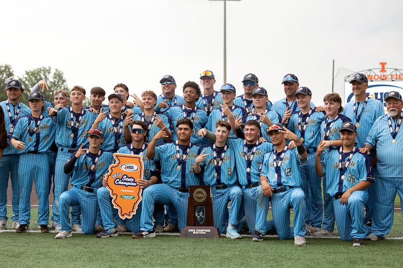 The Ottawa Marquette Crusaders celebrate their second consecutive first place state trophy Saturday, June 7, 2025, during the Class 1A state baseball final at Illinois Field in Champaign.