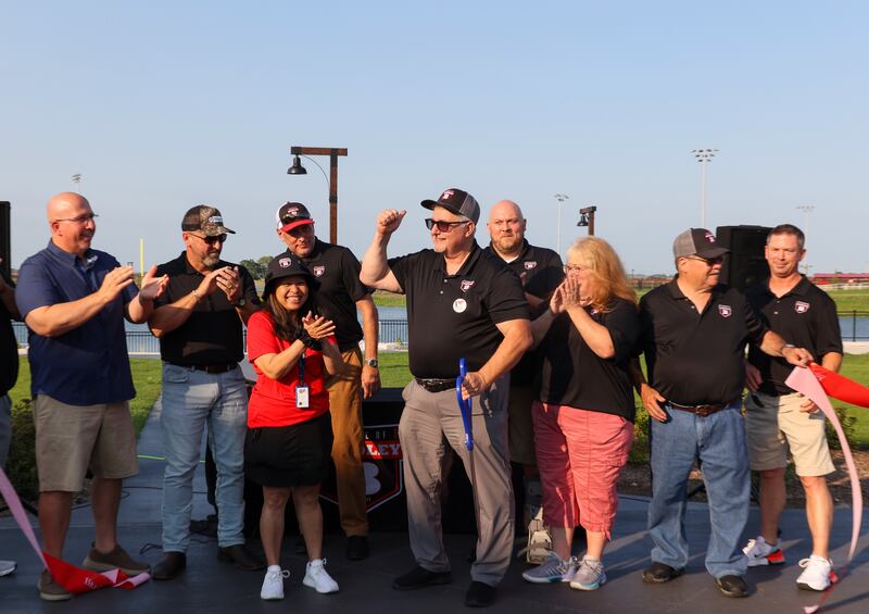 Bradley Mayor Mike Watson, center, pumps his fist in the air following a ribbon cutting for Bradley's 315 Sports Park with village trustees on Tuesday, July 29, 2025.