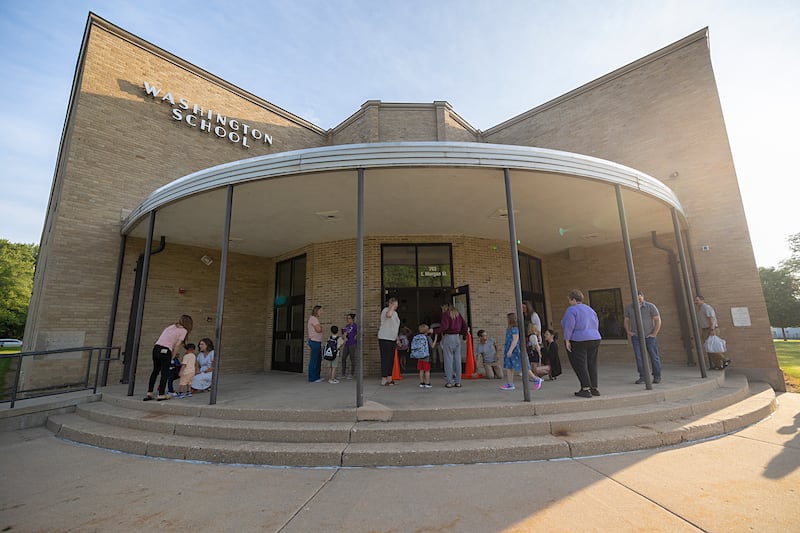Kids and parents gather outside of Washington School in Dixon Wednesday, Aug. 14, 2024 for the first day of school.