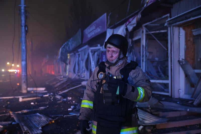 A rescuer works at a market destroyed by a Russian airstrike on Zaporizhzhia, Ukraine, Friday, Nov. 21, 2025. (AP Photo/Kateryna Klochko)
