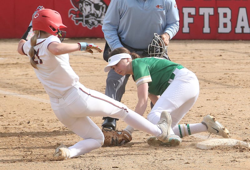 Ottawa's Piper Lewis slides safely into third base as Seneca's Kaylee Klinker misses the tag on Friday, May 2, 2025 at Ottawa High School.
