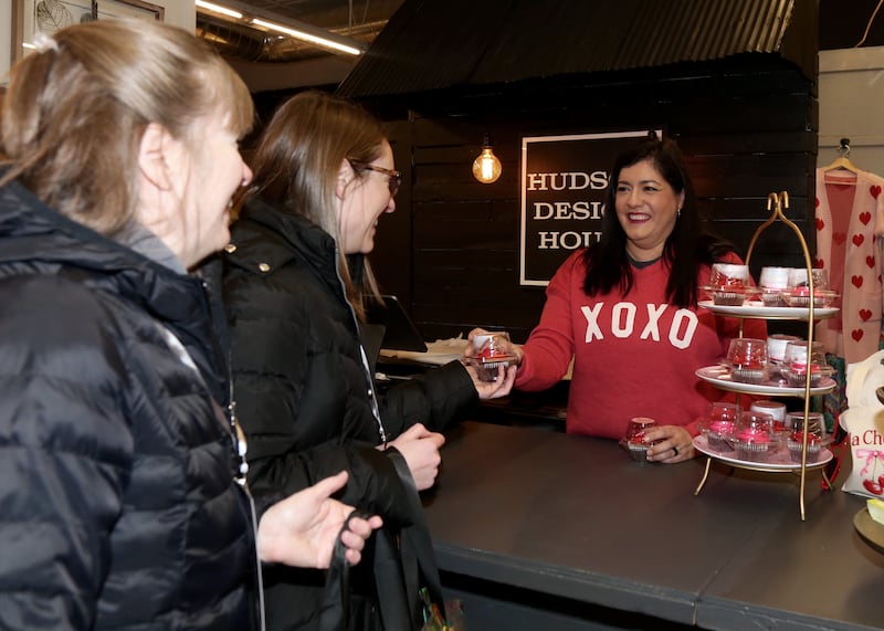 Leslie Hilderbrant of Hudson Design House (far right) gives cupcakes to Pat and Amanda Charapata at the 8th Annual Chocolate Walk for Charity in Oswego on Saturday, Feb. 8, 2025.