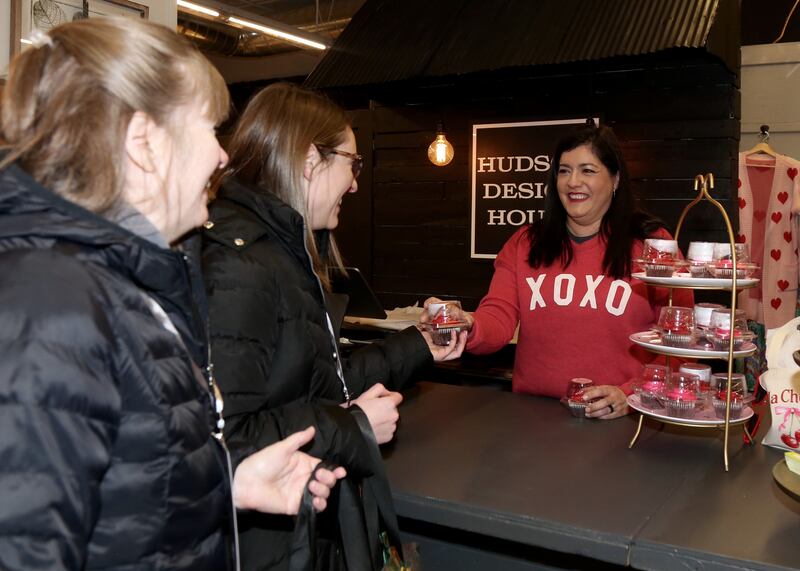 Leslie Hilderbrant of Hudson Design House (far right) gives cupcakes to Pat and Amanda Charapata at the 8th Annual Chocolate Walk for Charity in Oswego on Saturday, Feb. 8, 2025.
