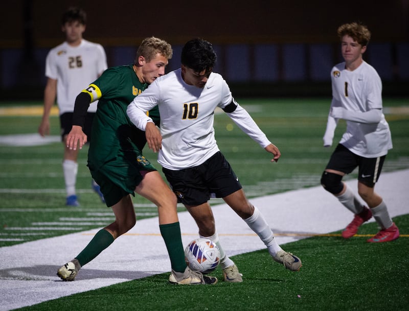 Herscher's Luis Parra controls the ball as Coal City's Luke Munsterman, left, challenges in a sectional game on Tuesday, October 28, 2025.