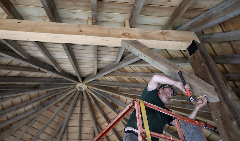 Alex Anderson, a timber smith, works on rebuilding a rare, eight-sided barn on Wednesday, April 22, 2026, at Richardson Adventure Farm in Spring Grove.