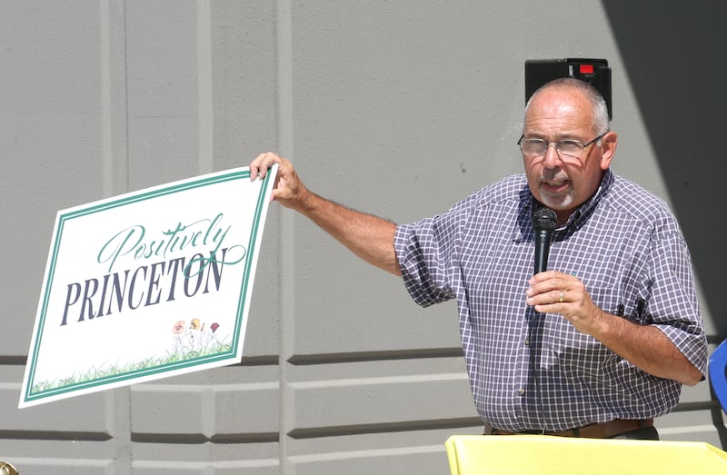 Princeton mayor Ray Mabry, holds a sign to present to Ollies Bargain Outlet during the grand opening celebration on Wednesday, Aug. 21, 2024 in Princeton. Gathered at the ceremony were about 50 people. The new distribution center is 615,000 square foot, which is about the equivalent of 11 football fields. It will serve 150 stores in the Midwest. The cost of the project is 68 million. that says "Positively Princeton while giving a speech during the Ollies Warehouse Bargains distribution grand opening on Wednesday, Aug. 21, 2024 in Princeton. Gathered at the ceremony were Brian McNabb Ollie's senior vice president and Princeton Mayor Ray Mabry. The new distribution center is 615,000 square foot, which is about the equivalent of 11 football fields. It will serve 150 stores in the Midwest. The cost of the project is 68 million.