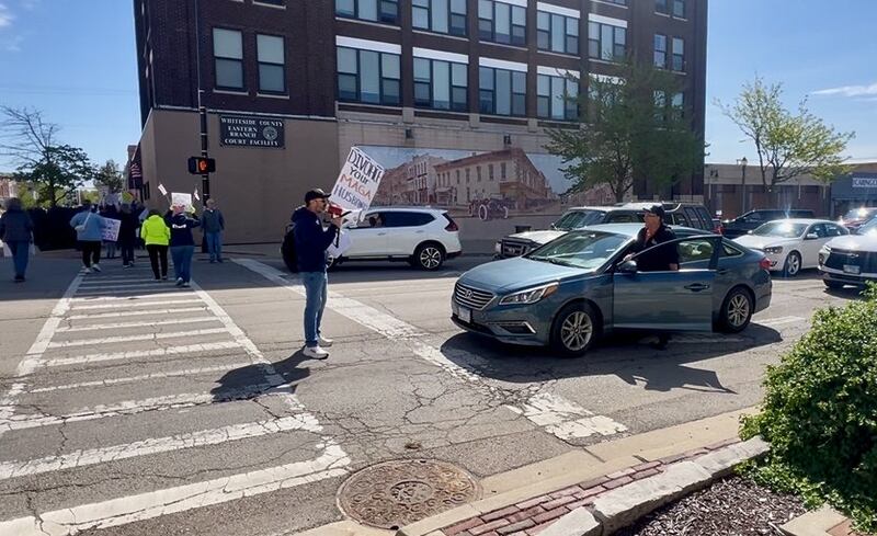 Protest leader Stephen Nalder shouts at drivers, blocking traffic, along First Avenue in Sterling during a march protesting the Trump administration on Saturday, May 3, 2025.