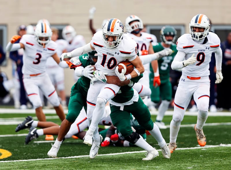 Oswego's Mariano Velasco (10) runs the ball during the varsity football second-round 8A playoff game between Oswego and Lane Tech on Saturday, Nov. 8, 2025 in Chicago.