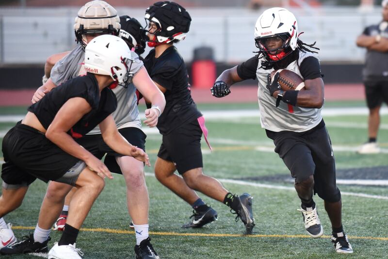 Bradley-Bourbonnais' Ky'ren Edmon, right, looks for running room during the first day of football practice Monday, Aug. 11, 2025.