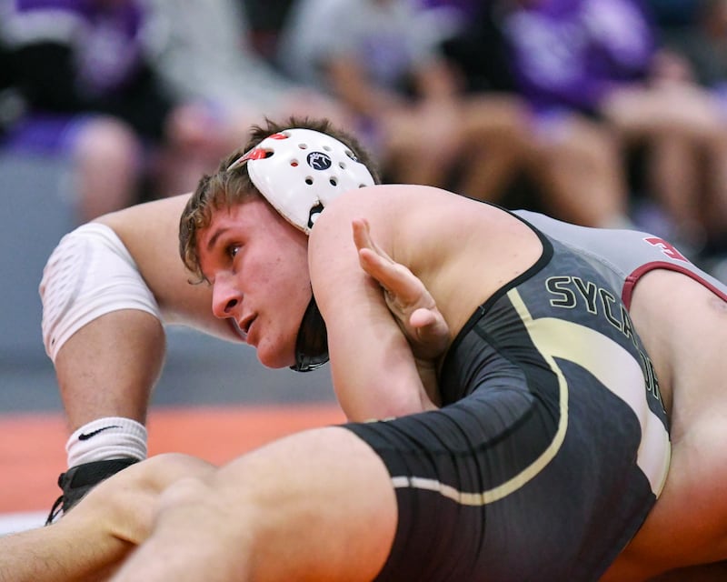 Tyler Lockhart of Sycamore, left, watches as he gets the near-fall while taking on David McDermott of Moline in the 126-weight class on Tuesday Dec.30, 2025, during the Flavin Invite held at DeKalb High School.