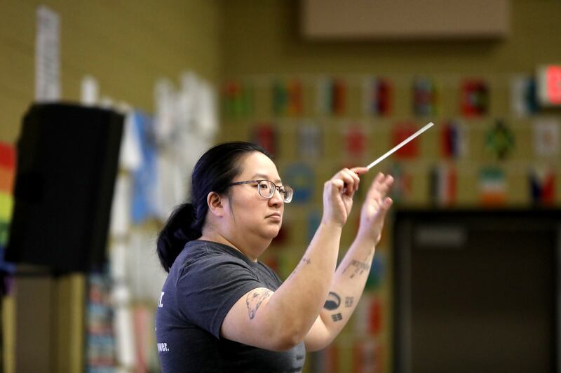 Murphy Junior High School Band Director Julianna Karvelius directs a seventh-grade brass class at the Plainfield school. Murphy Junior High School is part of Oswego Community Unit School District 308.