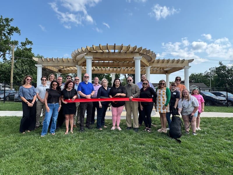 Sarah Hughes, owner of Furry Haven Premium Pet Care in Minooka, the  Minooka Mayor Ric Offerman, Chamber Ambassadors, and supporters celebrate her business with a ribbon cutting by the Channahon Minooka/Grundy County Chamber.