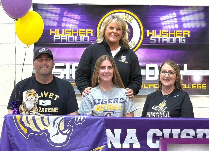 Recent Serena graduate and two-time Times All-Area Softball first-teamer RayElle Brennan – seated at center bookended by her parents, with Serena softball coach Kelly Baker standing behind – has committed to continue her education at Olivet Nazarene University in Bourbonnais and her softball career at the NAIA level with the Tigers.