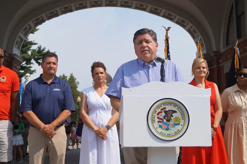 Gov. JB Pritzker speaks to reporters outside the Illinois State Fairgrounds after cutting a ribbon to officially open the fair on Thursday, August 7, 2025.
