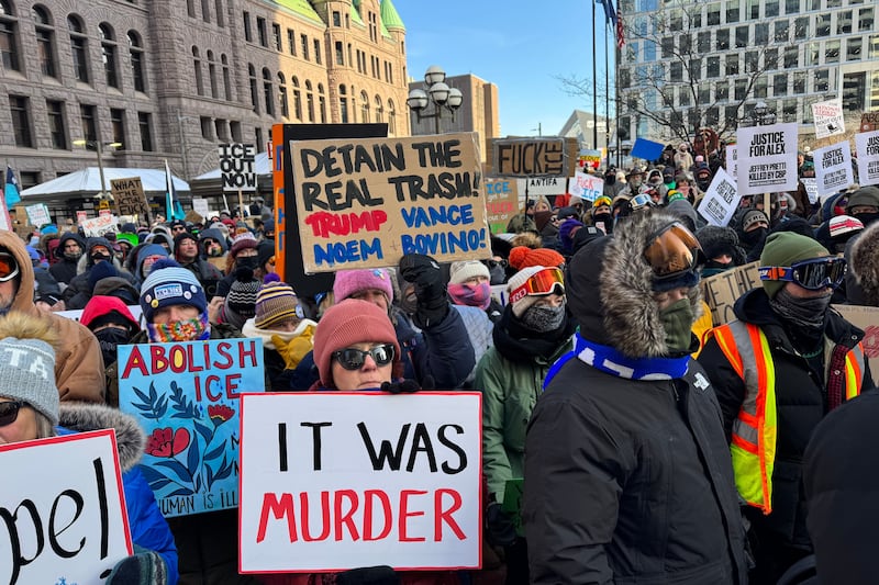 People participate in an anti-ICE rally Sunday, Jan. 25, 2026, in Minneapolis. (AP Photo/Jack Brook)