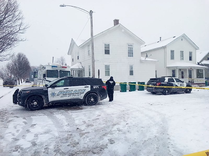 Joliet police vehicles block off the corner of Garnsey Avenue and Ward Street near a house where a 4-year-old boy and a 36-year-old woman were shot to death Sunday, Jan. 25, 2026.