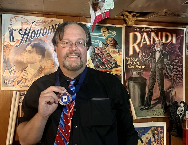 Jeremy “The Amazer” Haak holds his first-place medal for winning the Close-Up Contest at the Houdini Club of Wisconsin convention with his performance of “Sam the Bellhop,” a story-based card trick