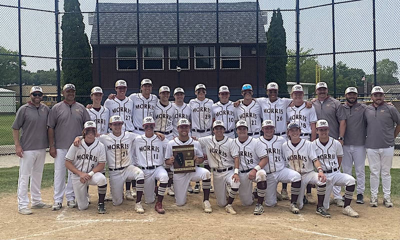 The Morris baseball team poses with its Class 3A Morris Regional championship plaque after a 10-0 win over LaSalle-Peru on Saturday.