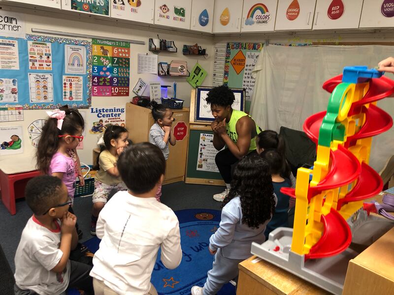 Volunteer Sierra Dunner demonstrated exercises to 3, 4 and 5-year-olds on Thursday, March 20, 2025, at Elgin's Two Rivers Head Start.
