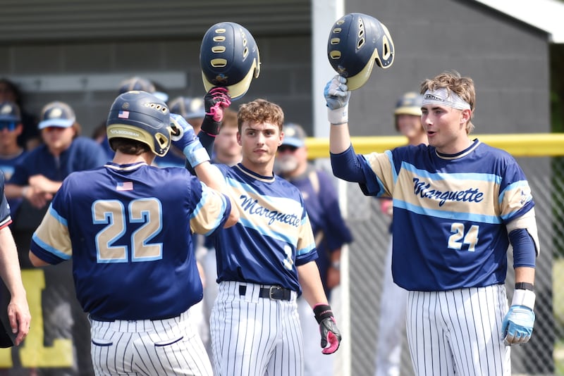 Marquette's Beau Thompson, center, and Anthony Couch, right, congratulate Griffin Dobberstein on his home run during the Class 2A Herscher Sectional semifinal against IC Catholic Wednesday, June 3, 2026.