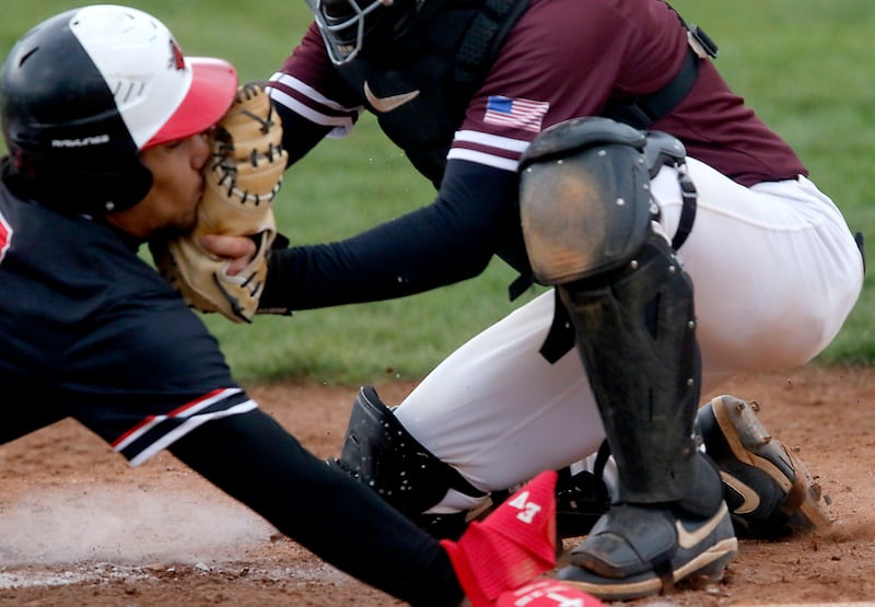 Huntley's Diego Herrera is tagged out as home plate by Prairie Ridge's Beckett Breseman during a Fox Valley Conference baseball game on Friday, May 1, 2026, at Prairie Ridge High School.